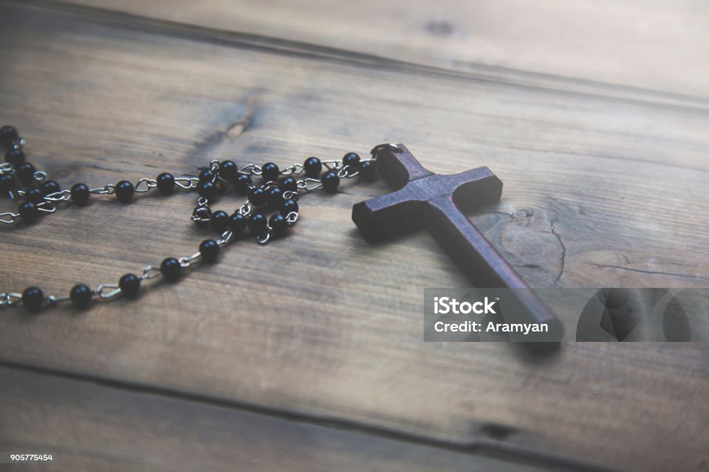 cross on the wooden table wooden cross on the wooden table background Catholicism Stock Photo