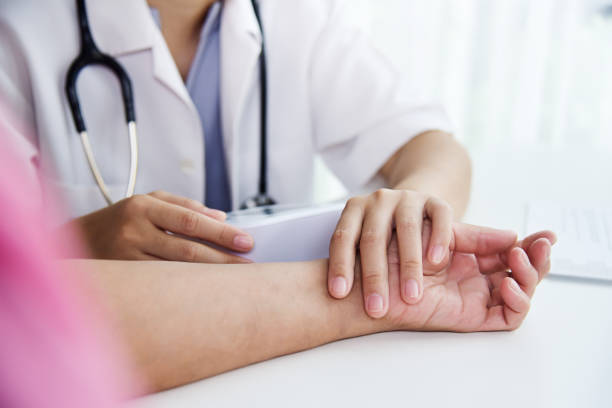 istock Female doctor checking patient pulse. 905784812