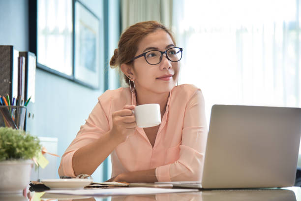 istock Female creative designer holding a cup of coffee. 905784830