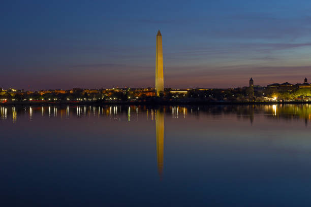 istock Washington Monument with reflection in waters of Tidal Basin at night. 905796248