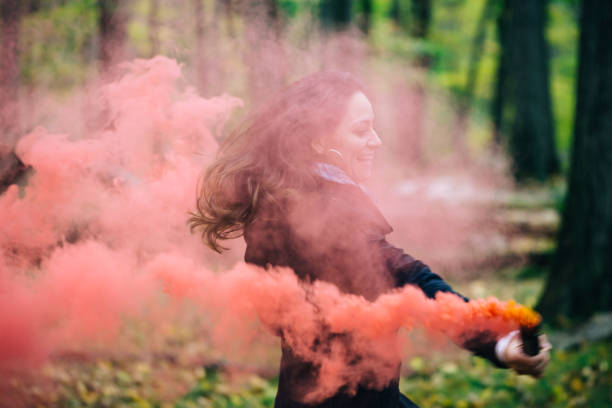 istock Woman with colorful smoke 905799678
