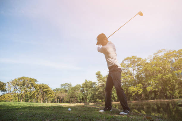 istock Asian man golf player swinging driver golf club on golf course. 905802696