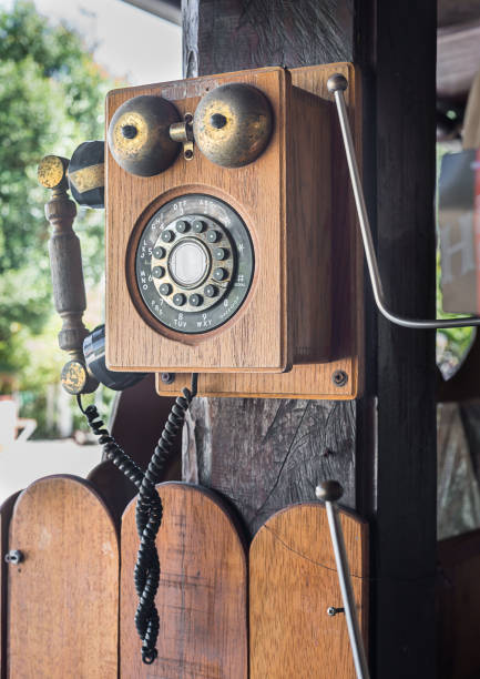 istock Vintage telephone hang on wooden pole 905803784