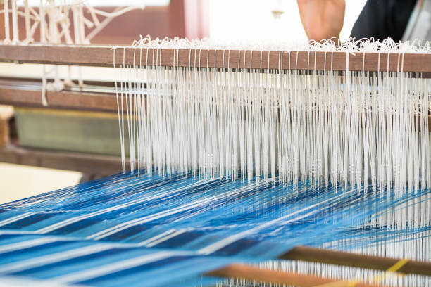 istock Weave silk cotton on the manual wood loom 905812314