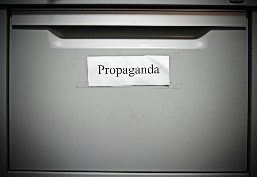 A filing cabinet drawer titled 'propoganda'