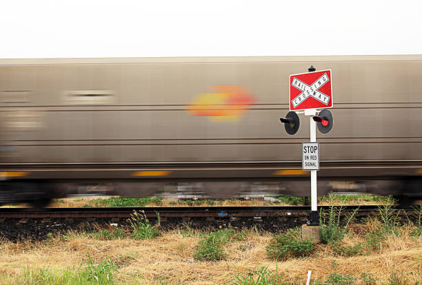rail crossing - railroad crossing train railroad track road sign stock-fotos und bilder