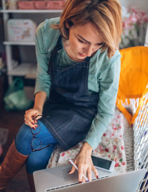 istock Creative young woman working on a lap top 905812828