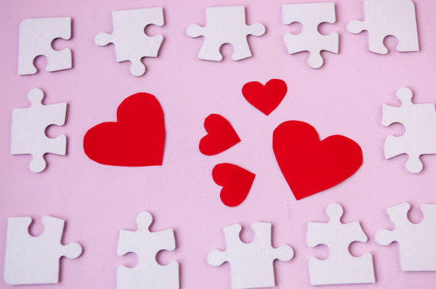 istock On a pink background a red heart in a puzzle frame, a valentines day card 905818862