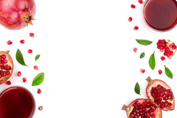 istock pomegranate juice with fresh pomegranate fruits isolated on white background with copy space for your text. Top view 905823588