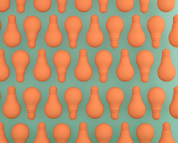 istock Creative idea pattern made of Light bulbs orange on green pastel background. Flat lay, minimal concept idea. 905828310