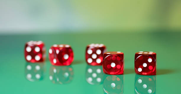 istock playing poker dice on green background 905828410