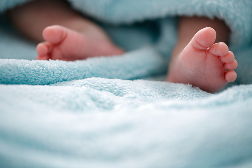 A close-up of tiny baby feet