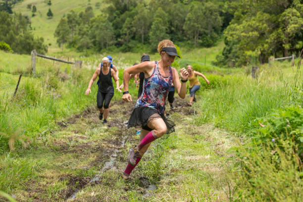 istock Mud Covered Mature Women in an Obstacle Course Bog 905836546