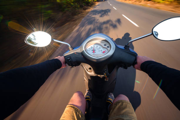 istock Rider driving scooter on an asphalt road. Motion blurred backgro 905836928