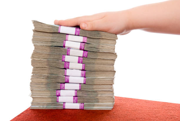 Hand and pile of money