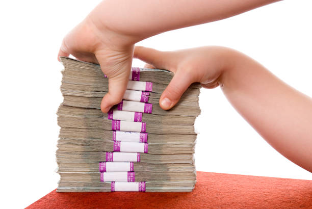 Hand and pile of money