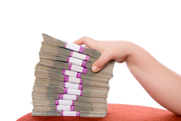 istock Hand and pile of money 905839680