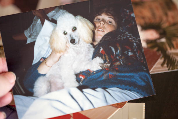 1980s Photo An old photograph of a sixteen year old girl with her pet poodle in 1989. Same model in background photos. 1980 1989 photos stock pictures, royalty-free photos & images