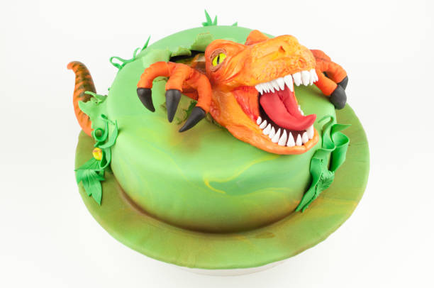 istock Art cake with dinosaur, decorated with green leaves. 905845682
