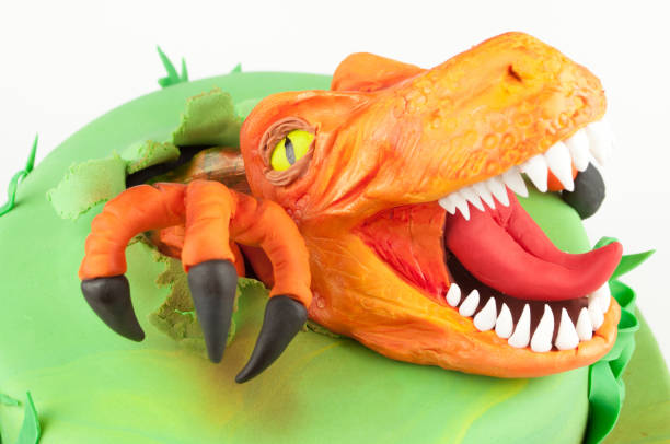 istock Art cake with dinosaur, decorated with green leaves. 905848042