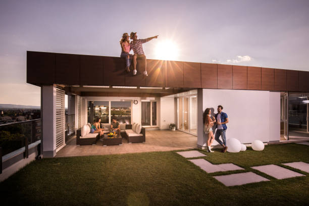 istock Three happy couples enjoying a day on a penthouse terrace. 905852818