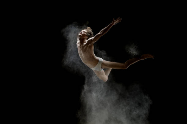 istock Young man jumping in a white dust cloud shot 905852948