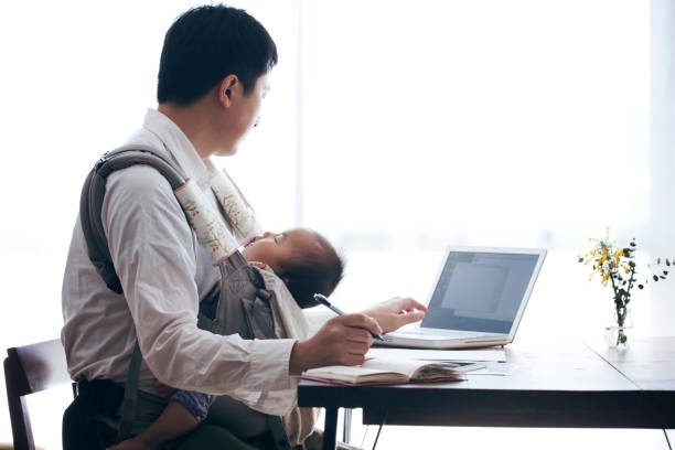 istock Father with baby working at home 905856600