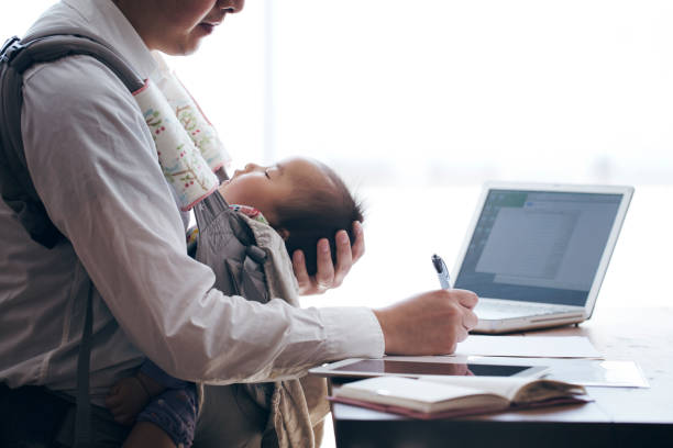 istock Father with baby working at home 905856862