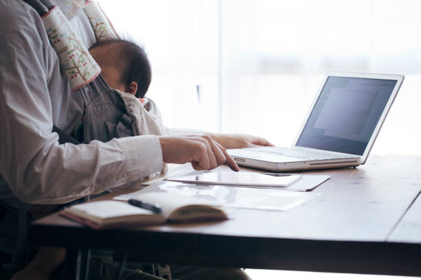 Father with baby working at home