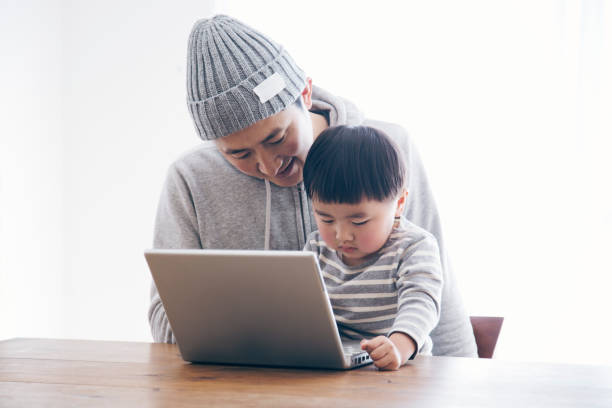 istock Father and son using a laptop together 905857158
