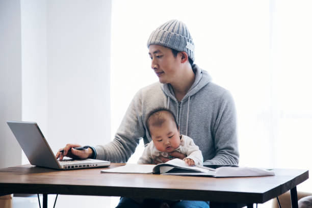 istock Father with baby working at home 905857202