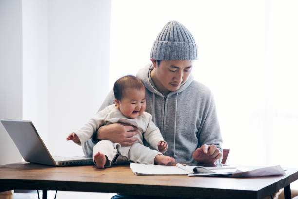 istock Father with baby working at home 905857206