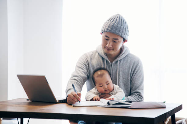 istock Father with baby working at home 905857252