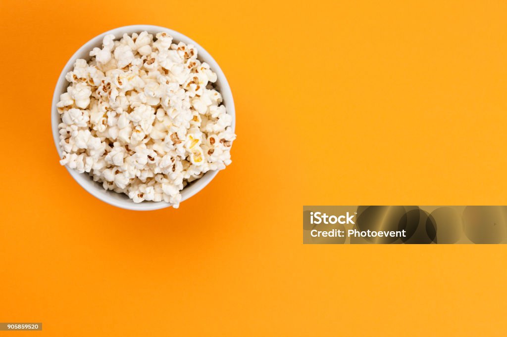 Popcorn - Isolated Popcorn on orange background Popcorn Stock Photo