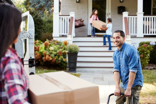 istock Children Helping Unload Boxes From Van On Family Moving In Day 905863102