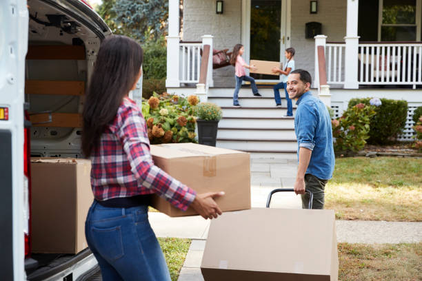 istock Children Helping Unload Boxes From Van On Family Moving In Day 905863108