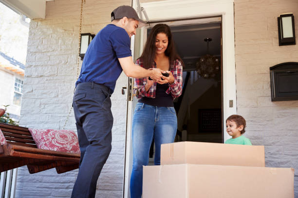 istock Courier Asking Woman To Confirm Delivery On Digital Tablet 905865376