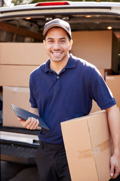 istock Portrait Of Courier With Digital Tablet Delivering Package 905865690