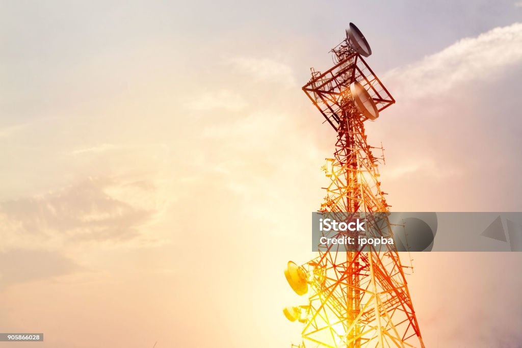 Abstract telecommunication tower Antenna and satellite dish at sunset sky background Telecommunications Equipment Stock Photo