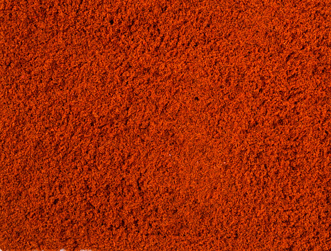 Texture background. Red paprika powder Top view