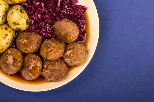 Photo of Swedish or Norwegian Meatballs With Boiled Potatoes Red Cabbage And Gravy