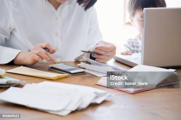 Mother With Son Working At Home Stock Photo - Download Image Now - Home Finances, Stay-at-Home Mother, Wellbeing
