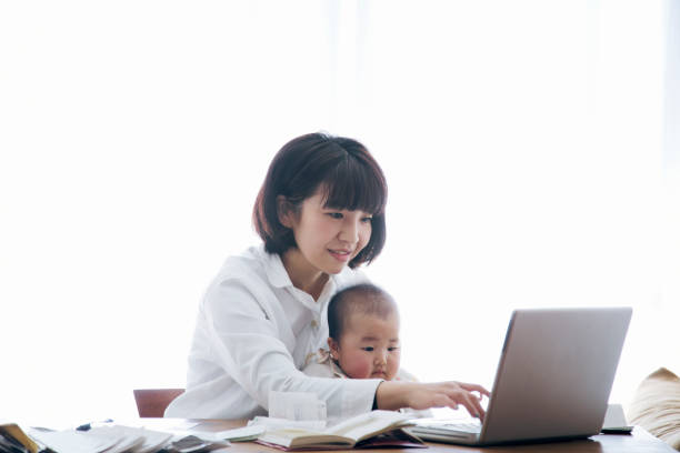 istock Mother with baby working at home 905869556