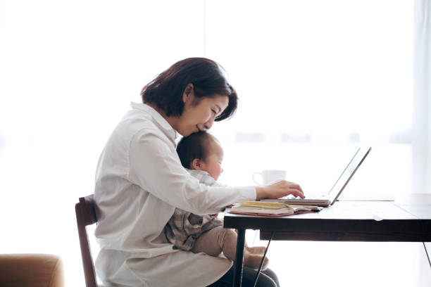 istock Mother with baby working at home 905869748