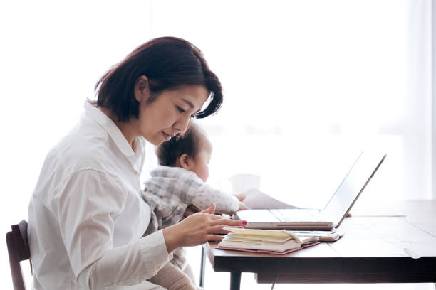 istock Mother with baby working at home 905869754