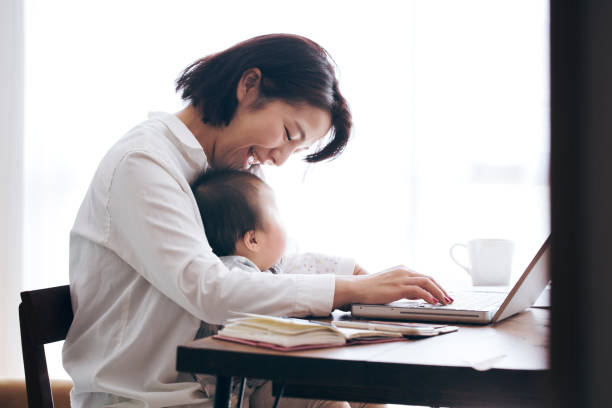 istock Mother with baby working at home 905869756