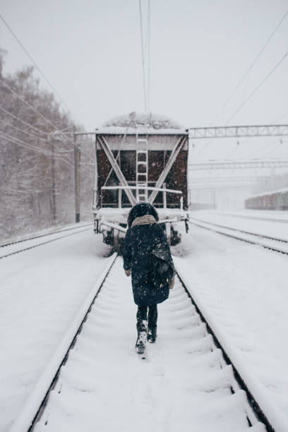 istock Girl for a Train rails in Winter. 905871224