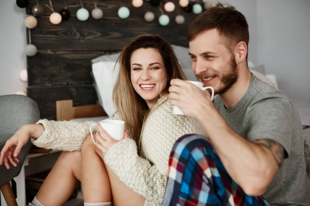 istock Young couple drinking coffee in bed 905878912