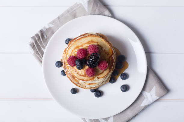 istock Pancakes with berries and honey on the plate 905879422