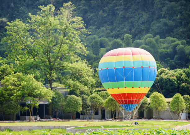istock Colorful hot air balloon is ready for flight. Summer landscape 905879592
